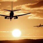 Image of airplanes flying against a sunset
