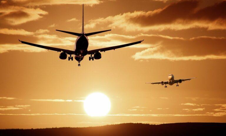 Image of airplanes flying against a sunset