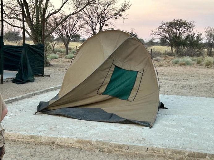 a tent pitched on a slab of concrete