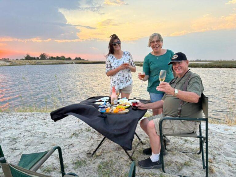 three people next to the river toasting a successful hunt.