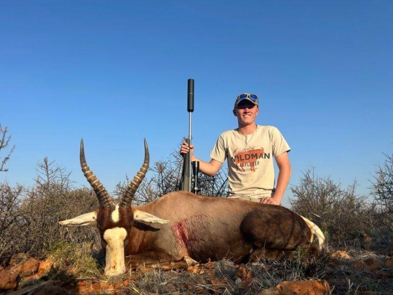 man posing with blesbok that was harvested.