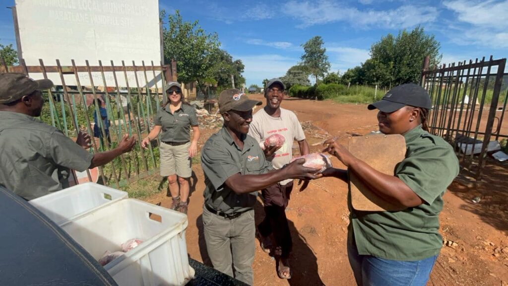 Game Hunting Safaris distributing meat packages at a local rubbish dump