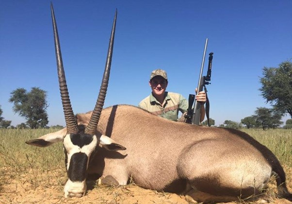 Man posing with large gemsbok he harvested