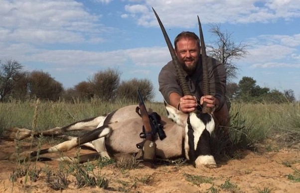 Man posing with a beautiful long horned gemsbok trophy